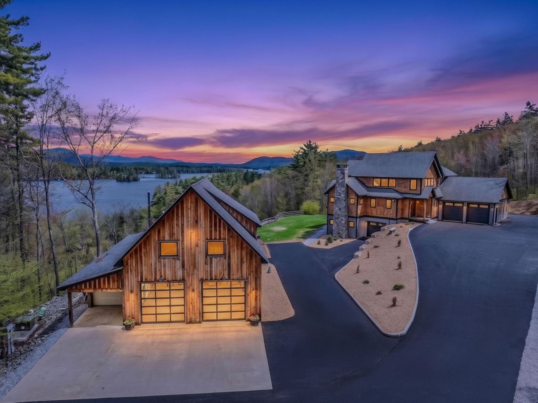 Twilight aerial of a lakeside New Hampshire estate